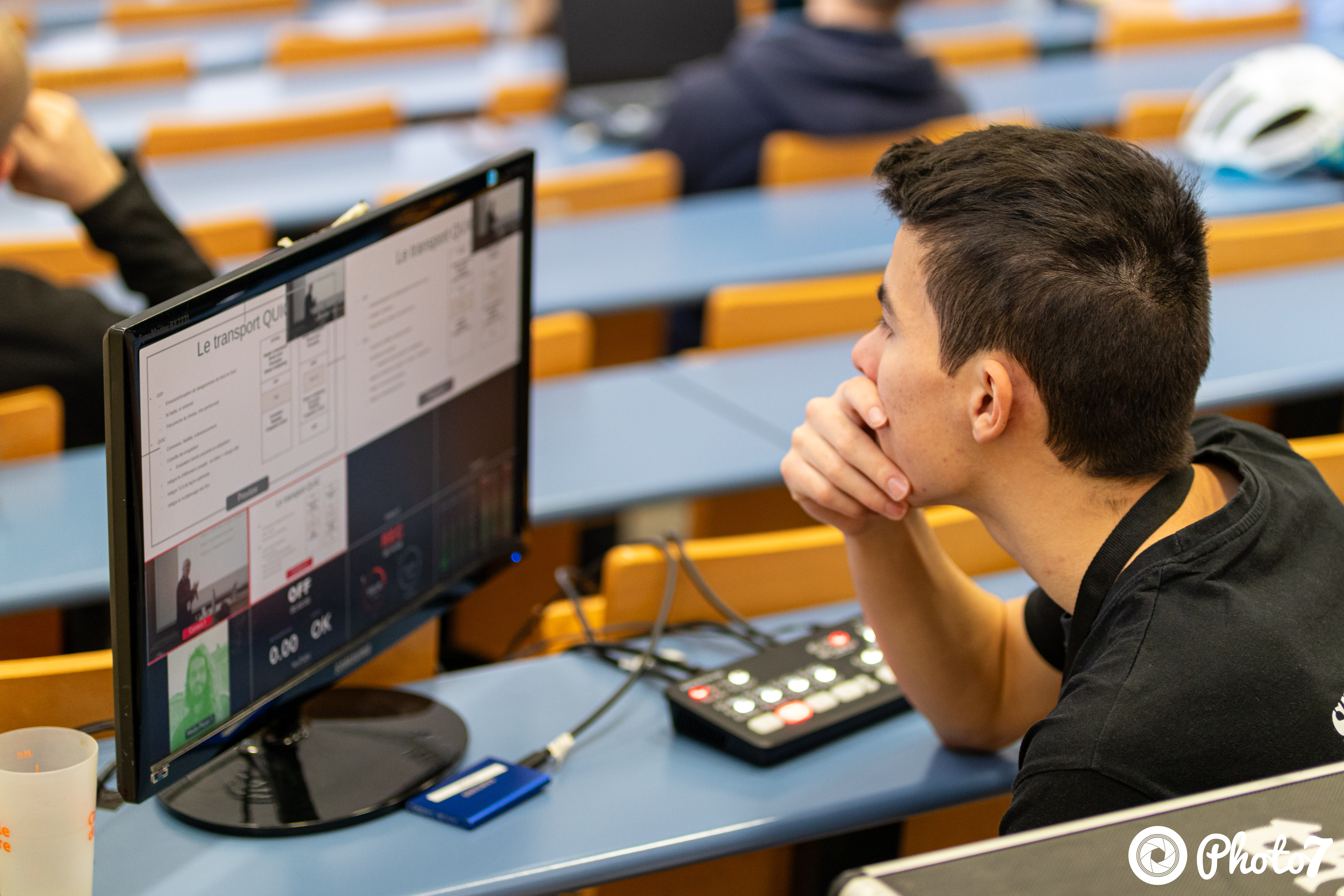 Picture of me using a Blackmagic Atem Extreme Iso mini control booth to reccord a conference. 
                    This is the tool I used to familiarize myself with control booths before making my way 
                    to heavier equipement.  